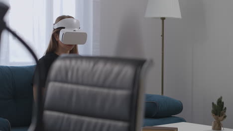 modern-technology-of-virtual-reality-for-daily-use-woman-is-wearing-HMD-display-in-home-looking-around-interactive-entertainment-and-video